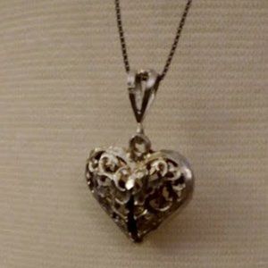 Filigree heart pendent, marked S.S., on a sterling 18"chain.